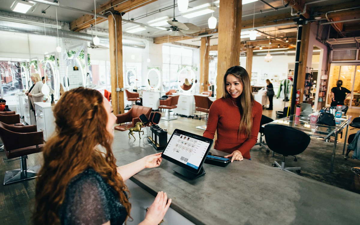 Business owner helping a customer at the counter
